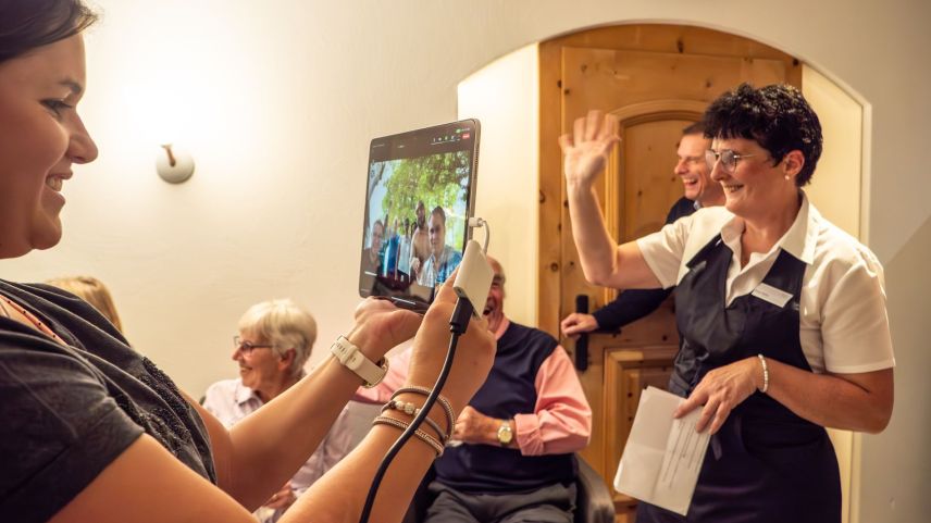 Damara Lenz (links) mit geglückter Videoschaltung nach Costa Rica zu Sandro Bernasconi und dem Waldhaus-Personal. Rechts VMMO-Präsident Hanspeter Egli sowie Milchbäuerin und Tätschmeisterin Petra Arto. Foto: Jon Duschletta
