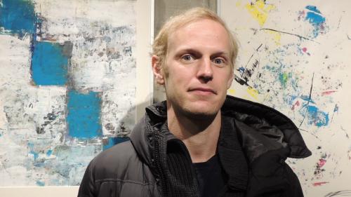 Nicolas Neumeier bei seiner Ausstellung in Scuol zwischen «Morgengrauen» und «Sunstorm». Foto: Benedict Stecher